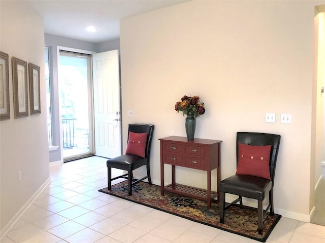 living area featuring tile patterned flooring and baseboards