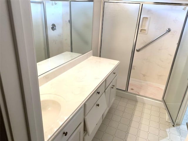 full bathroom featuring vanity, a shower stall, and tile patterned floors