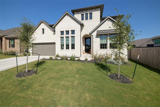 view of front of house featuring concrete driveway, fence, brick siding, and a front lawn