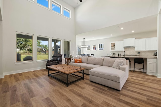 living room featuring recessed lighting, baseboards, and wood finished floors