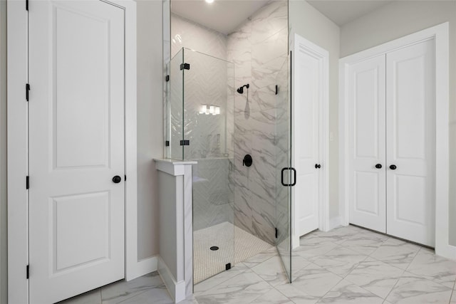 full bath with baseboards, marble finish floor, and a marble finish shower