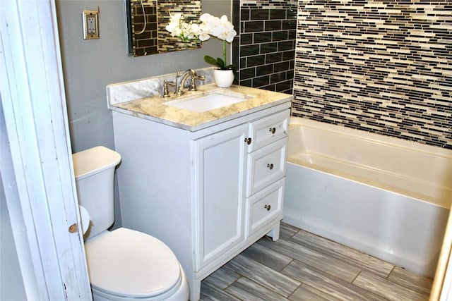 full bath featuring vanity, toilet, and a bathtub