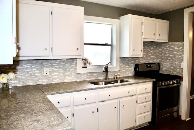 kitchen with white cabinetry, stainless steel electric range oven, tasteful backsplash, and a sink