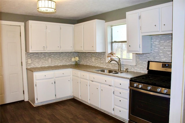 kitchen featuring dark wood-style floors, gas stove, white cabinetry, and a sink