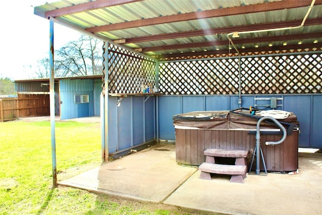 view of patio / terrace featuring an AC wall unit, a hot tub, and fence