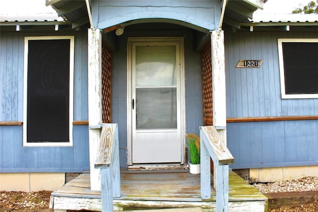 entrance to property featuring metal roof