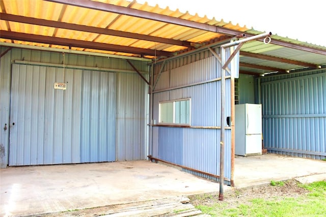 1221 Giddings St, Lexington, TX 78947 - garage featuring freestanding refrigerator