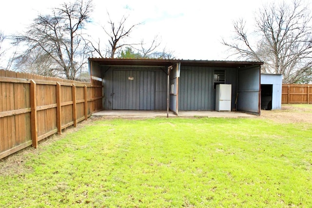 view of pole building featuring fence and a lawn