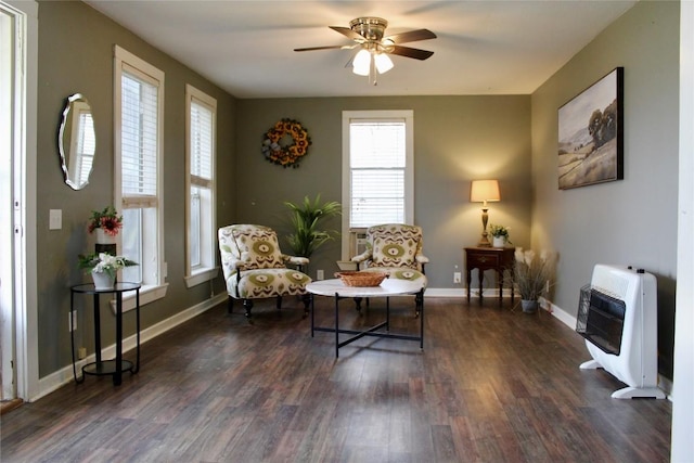 1221 Giddings St, Lexington, TX 78947 - living area with heating unit, dark wood-type flooring, a ceiling fan, and plenty of natural light