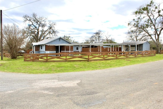 ranch-style home featuring an exterior structure and an outdoor structure