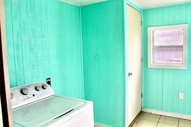 washroom with washer / dryer, light tile patterned floors, and laundry area