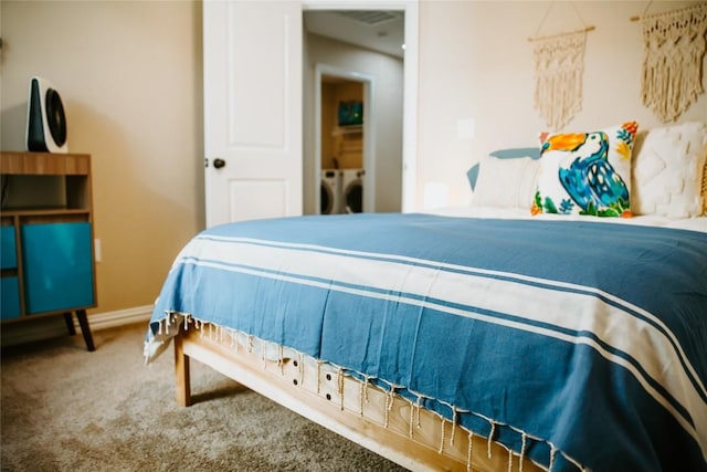 bedroom featuring baseboards, carpet, and washing machine and clothes dryer