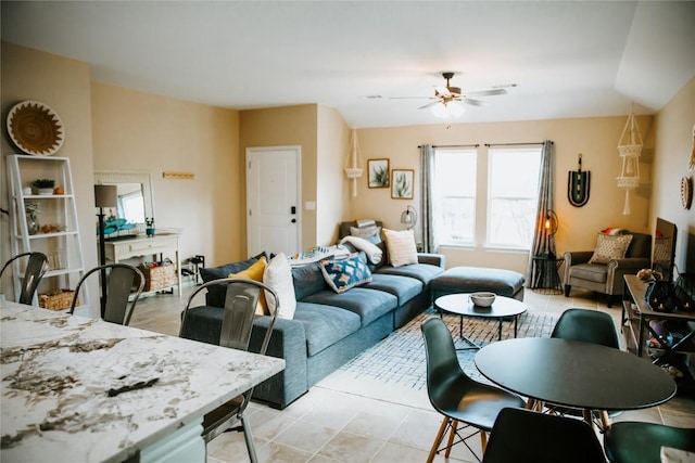 living area featuring light tile patterned floors and a ceiling fan