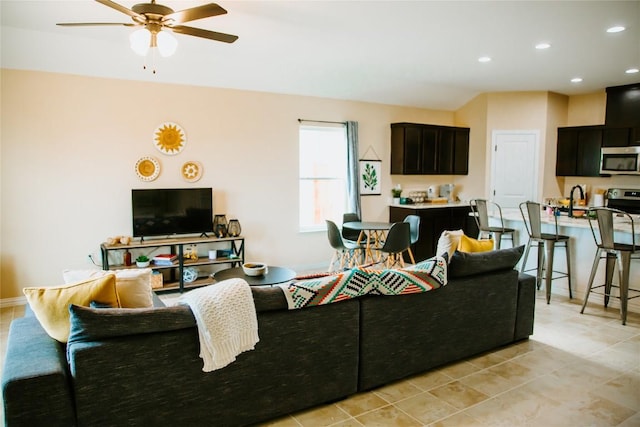 living room with light tile patterned flooring, recessed lighting, baseboards, and ceiling fan