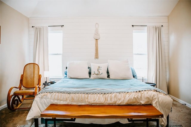 bedroom featuring vaulted ceiling, baseboards, and carpet floors