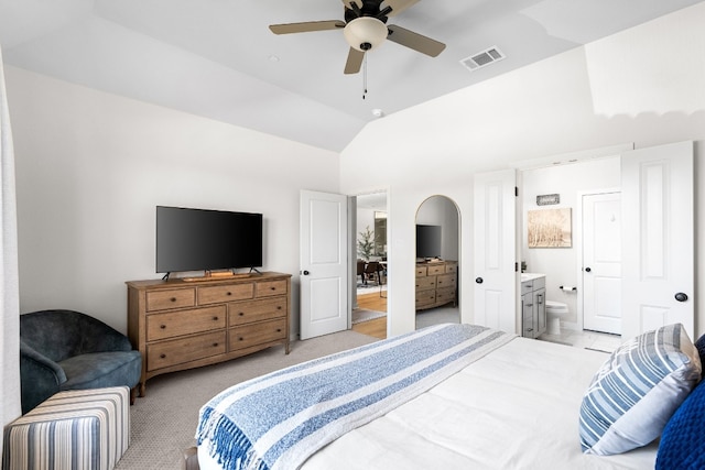 bedroom with visible vents, ensuite bath, lofted ceiling, ceiling fan, and light carpet