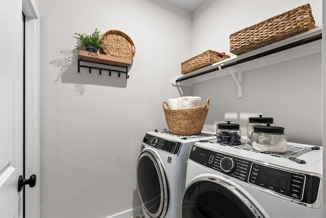 washroom featuring laundry area and washing machine and dryer