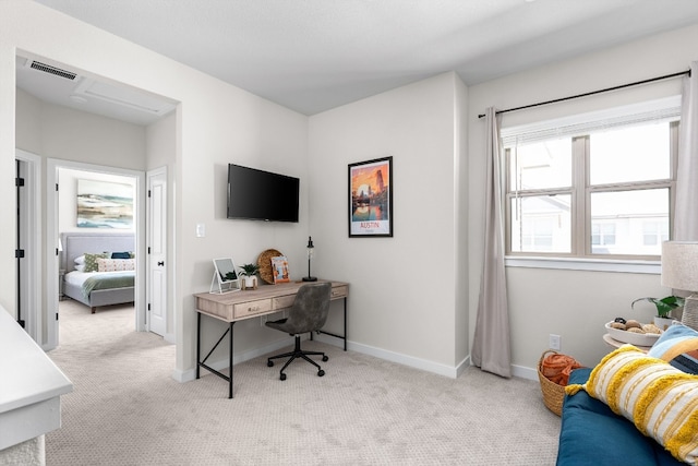 carpeted home office featuring visible vents and baseboards