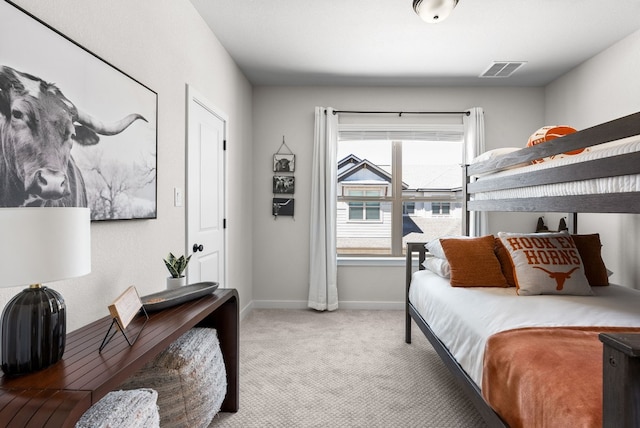 carpeted bedroom featuring baseboards and visible vents