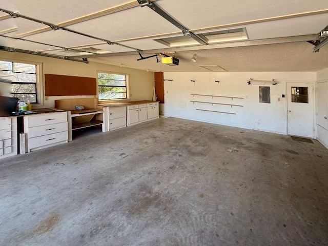 garage featuring electric panel and a garage door opener