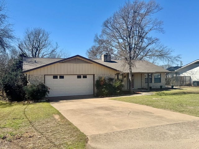 ranch-style house featuring a front lawn, roof with shingles, a chimney, a garage, and driveway