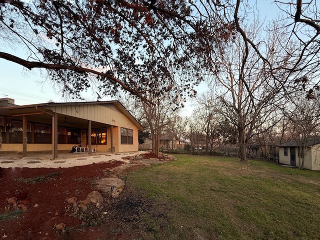 view of yard with an attached carport and a patio