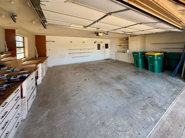 garage featuring electric panel and a garage door opener