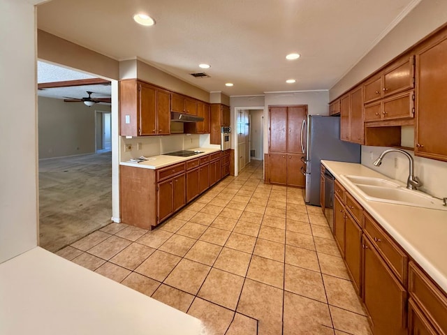 kitchen featuring a sink, stainless steel appliances, light countertops, and light tile patterned floors