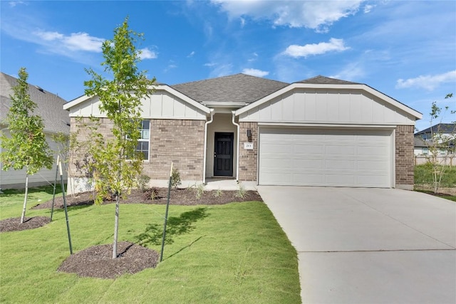 213 Seattle Slew Dr, Jarrell, TX 76537 - single story home featuring brick siding, a garage, driveway, board and batten siding, and a front lawn