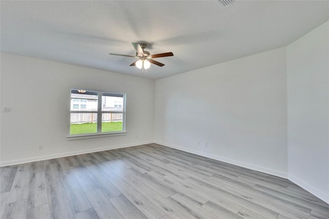 213 Seattle Slew Dr, Jarrell, TX 76537 - spare room with wood finished floors, a ceiling fan, and baseboards