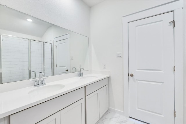 213 Seattle Slew Dr, Jarrell, TX 76537 - bathroom with marble finish floors, double vanity, a shower stall, baseboards, and recessed lighting