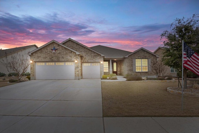 single story home featuring concrete driveway and a garage