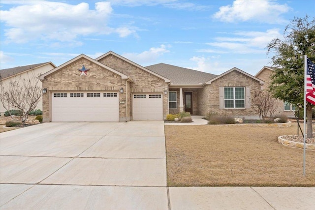 ranch-style house featuring brick siding, an attached garage, a shingled roof, and driveway