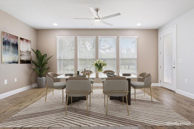 dining area featuring recessed lighting, wood finished floors, and baseboards