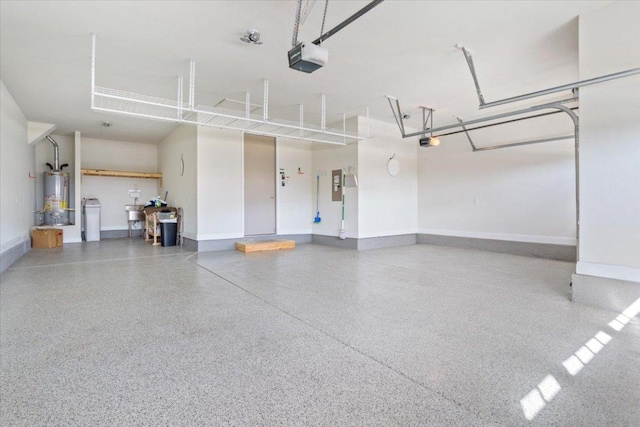 garage featuring a garage door opener, water heater, and baseboards