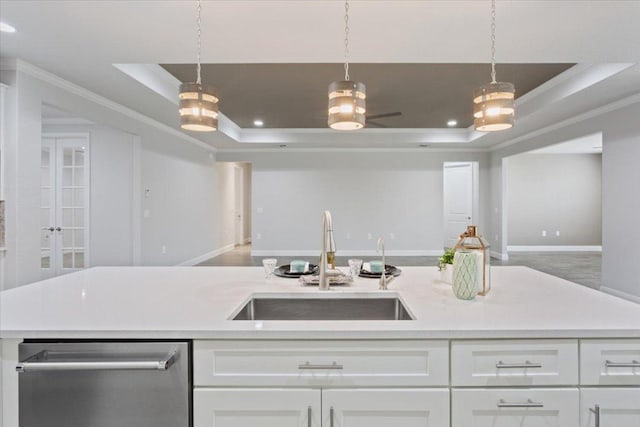 kitchen featuring a sink, a raised ceiling, open floor plan, and light countertops