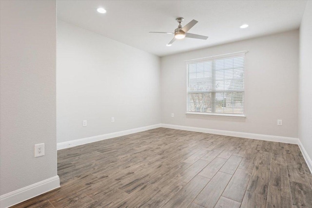 unfurnished room with ceiling fan, baseboards, wood finished floors, and recessed lighting