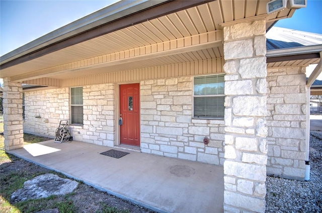 property entrance with stone siding