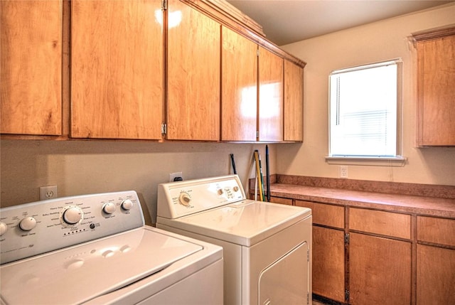 laundry area featuring washing machine and dryer and cabinet space