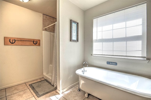 full bathroom with a shower with shower curtain, a freestanding tub, baseboards, and tile patterned flooring