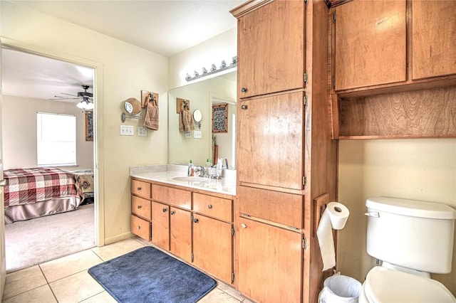 bathroom featuring tile patterned floors, toilet, ensuite bathroom, ceiling fan, and vanity