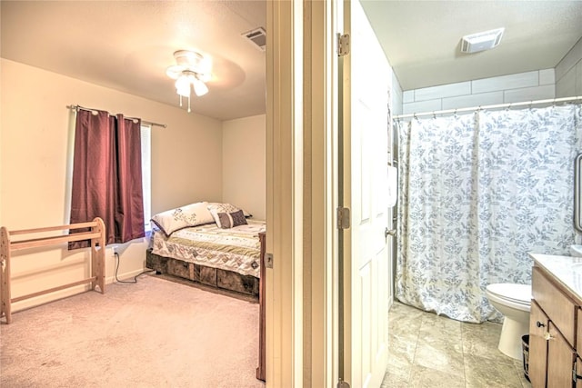 bedroom with visible vents, light colored carpet, and a ceiling fan