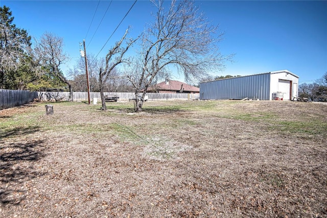 view of yard with an outbuilding and fence