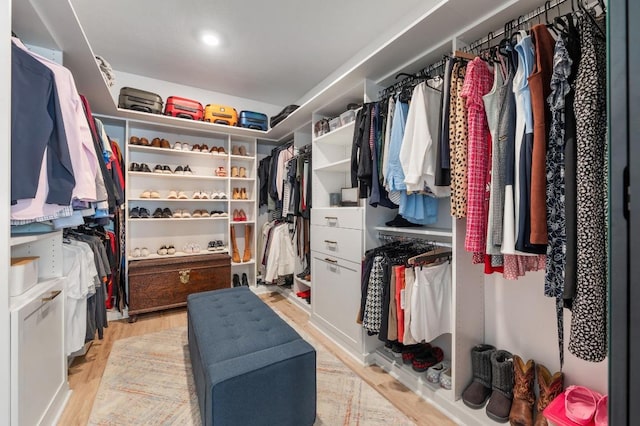 walk in closet with light wood-style flooring