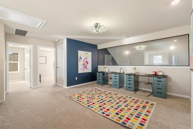 carpeted home office featuring visible vents and baseboards