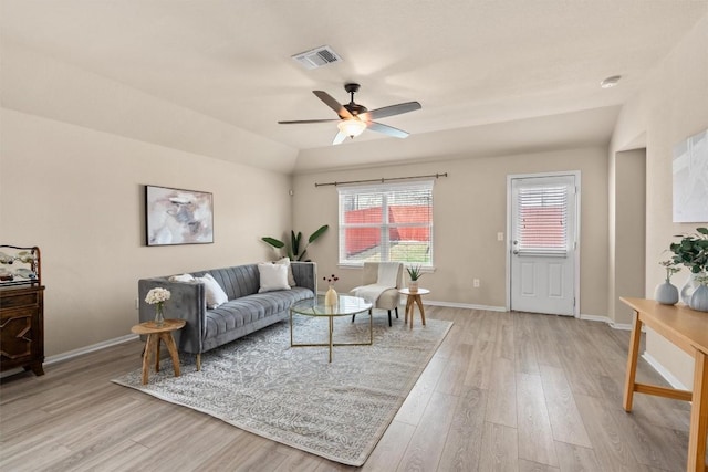 living area with visible vents, baseboards, lofted ceiling, ceiling fan, and light wood-style floors