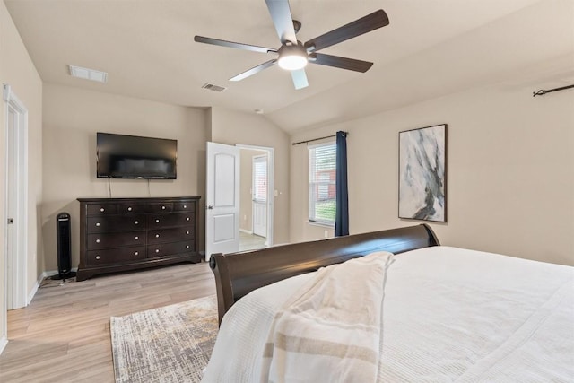 bedroom featuring visible vents, light wood-style floors, ceiling fan, and vaulted ceiling