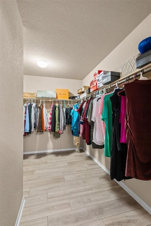 walk in closet featuring wood finished floors