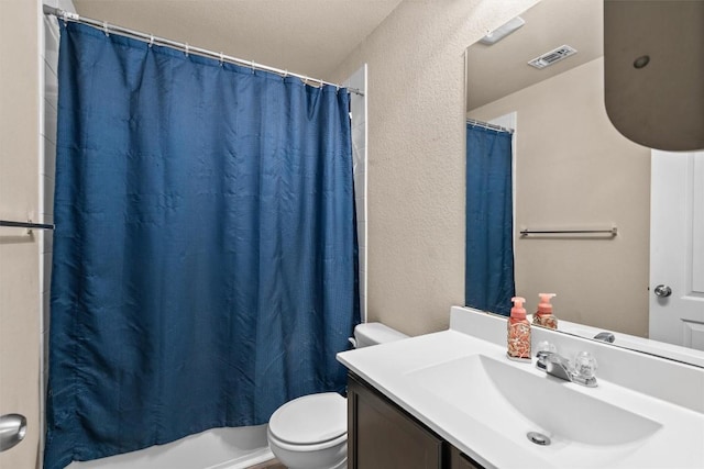 full bath featuring visible vents, toilet, shower / tub combo with curtain, a textured wall, and vanity