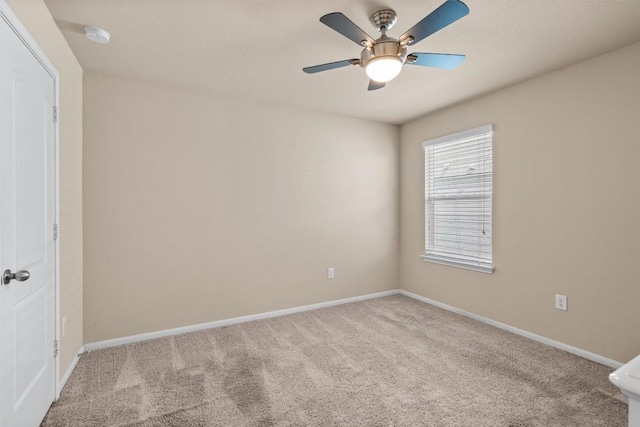 empty room featuring baseboards, carpet, and ceiling fan